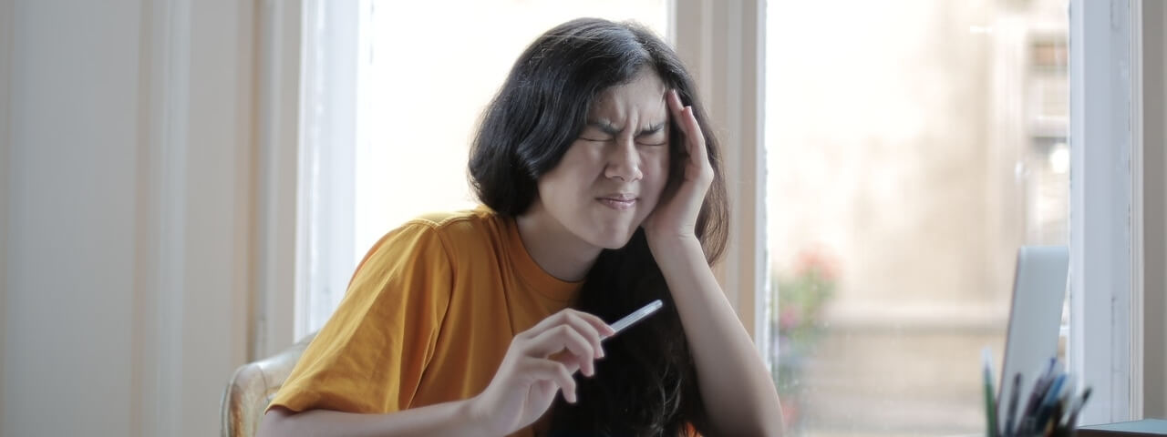 asian girl having a headache